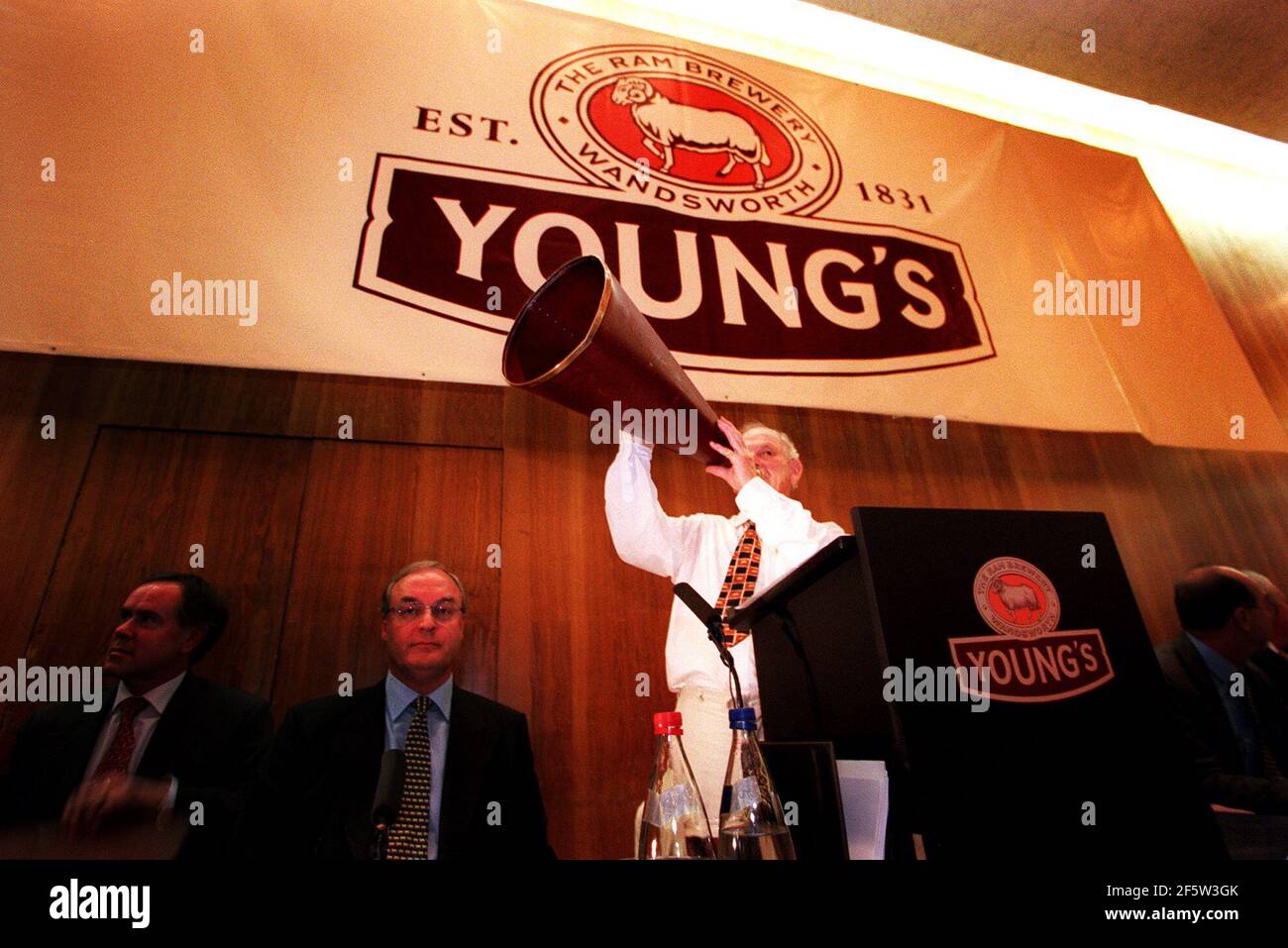 Young's Chairman John Young dismisses shareholders concerns by reiterating his point using a megaphone at Wandsworth town hall in London. photograph by mark chilvers. Stock Photo