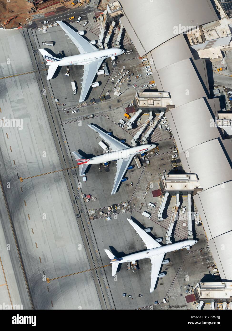 Three quadrijets airplanes side by side. Aerial view of Tom Bradley International Terminal (TBIT Terminal) at LAX Airport. Four engines aircraft. Stock Photo