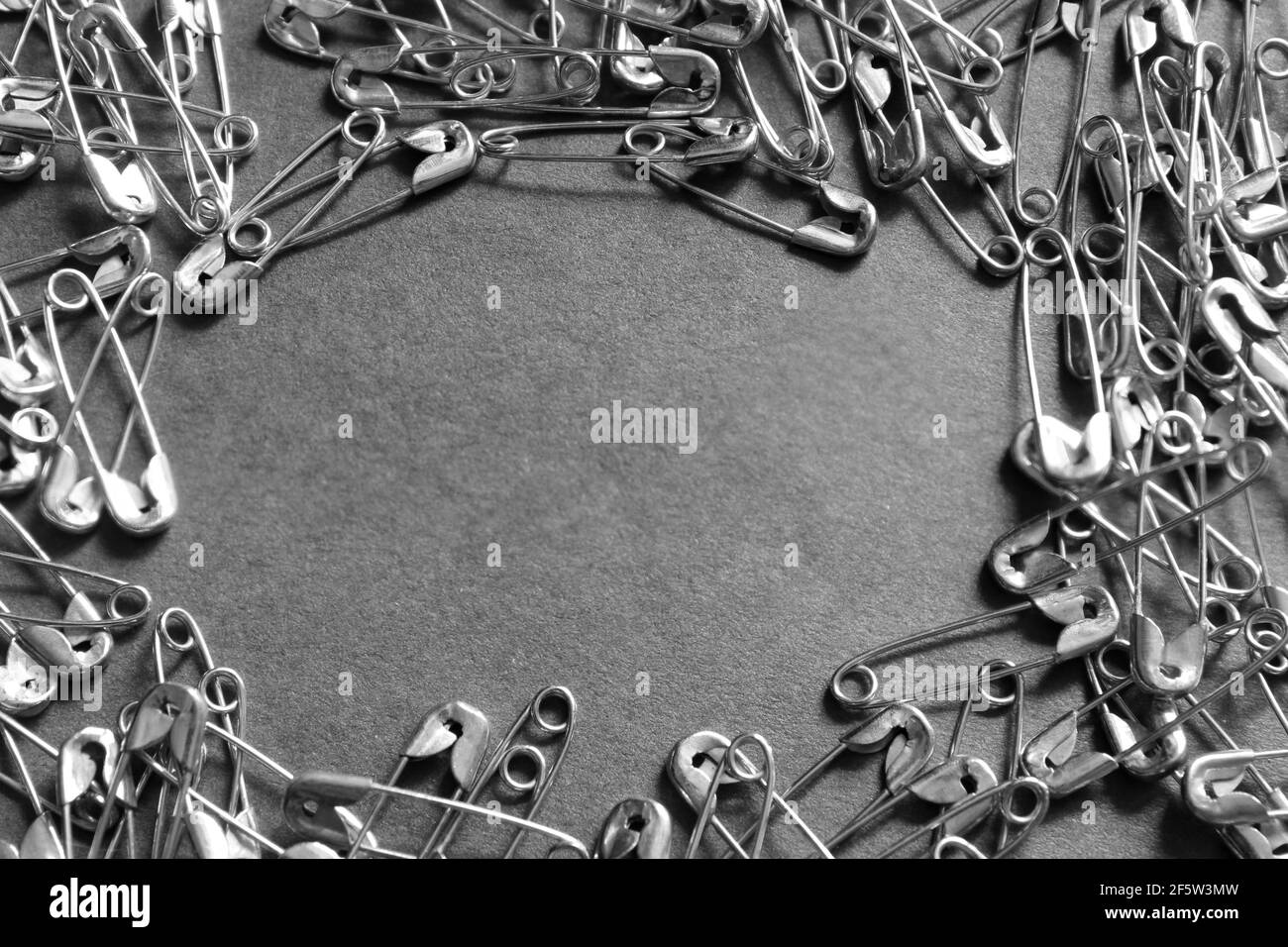 Safety pin on a dark background. Selective focus. Stock Photo