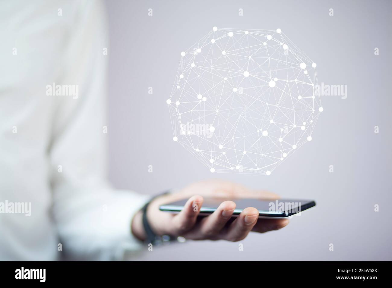 Businessman on blurred background using circle igital data network with mobile phone Stock Photo