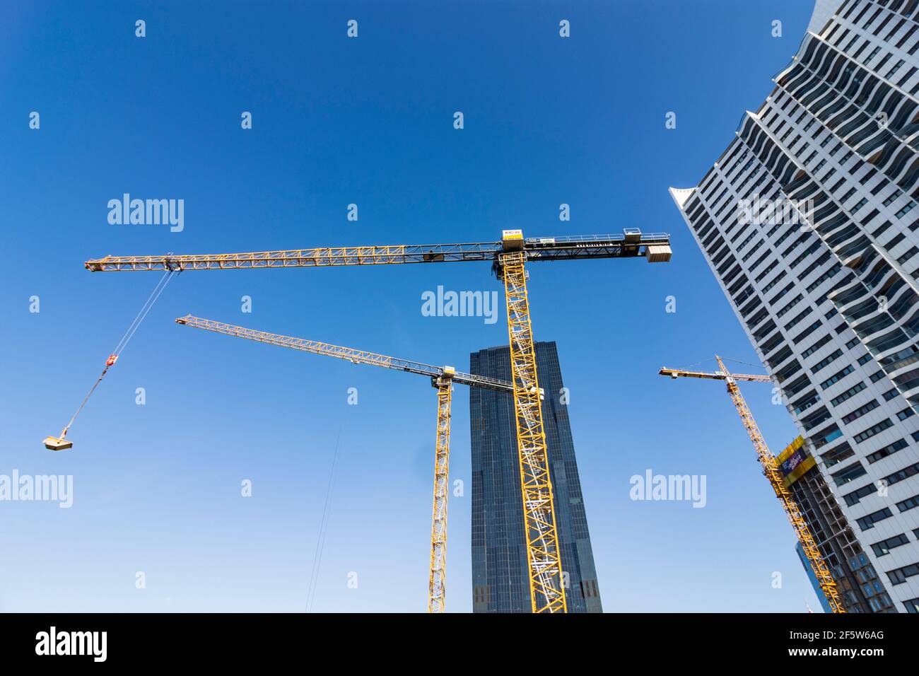 Wien, Vienna: cranes at construction site, blue sky, DC Tower 1, highrise 'Hochhaus Neue Donau', project 'Danube Flats' in 22. Donaustadt, Wien, Austr Stock Photo