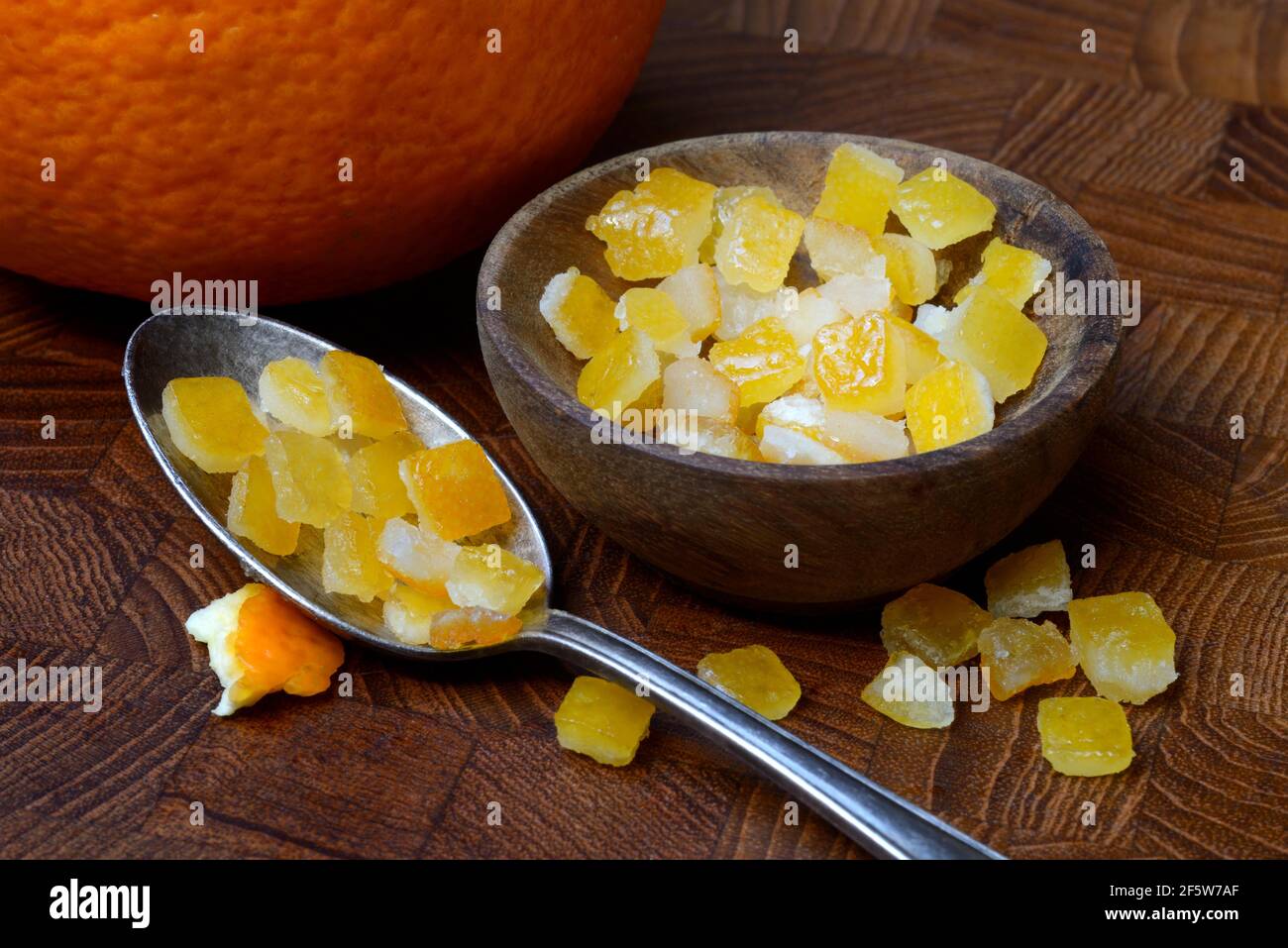 Candied orange peel cubes in small bowls and spoon, Germany Stock Photo Alamy