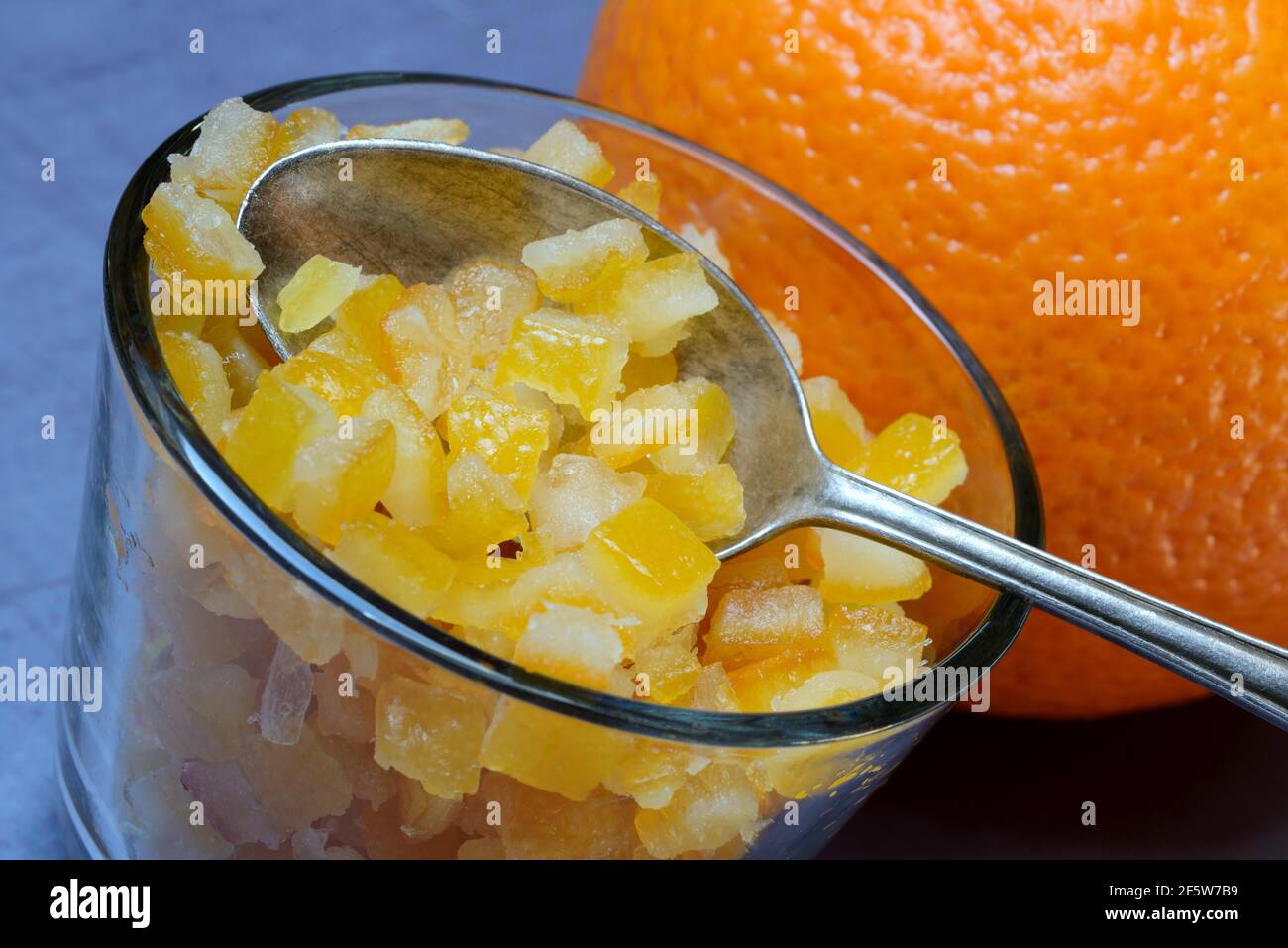 Candied orange peel cubes in glass with spoon, Germany Stock Photo Alamy
