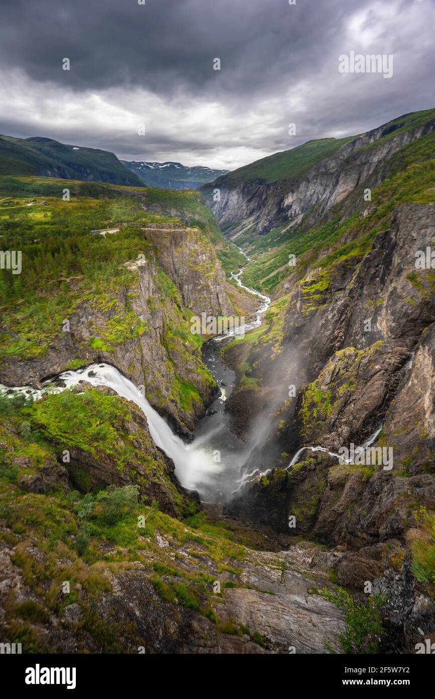 View into the river valley with waterfall Voringfossen, river Bjoreio falls down a rock face, valley with river, Eidfjord, Norway Stock Photo