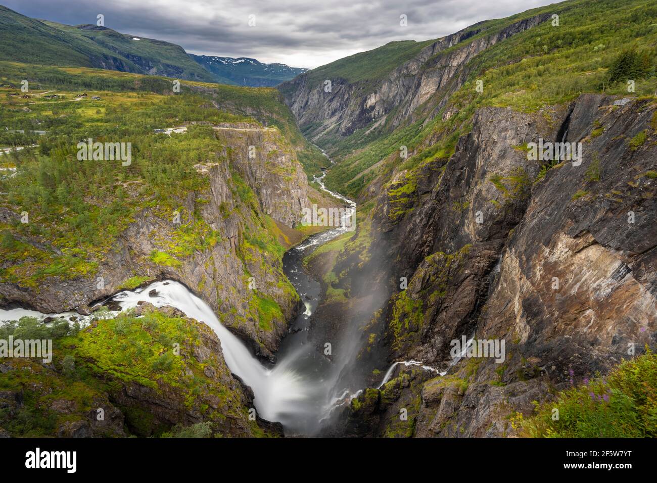 View into the river valley with waterfall Voringfossen, river Bjoreio falls down a rock face, valley with river, Eidfjord, Norway Stock Photo