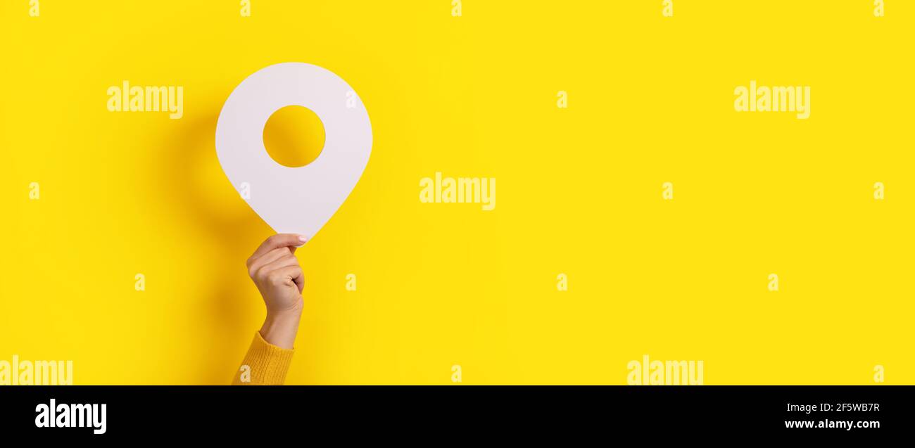 map pointer 3d pin in hand over yellow background Stock Photo