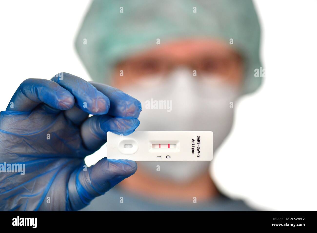 Medical staff shows positive antigen rapid test, test cassette, Corona crisis, Germany Stock Photo