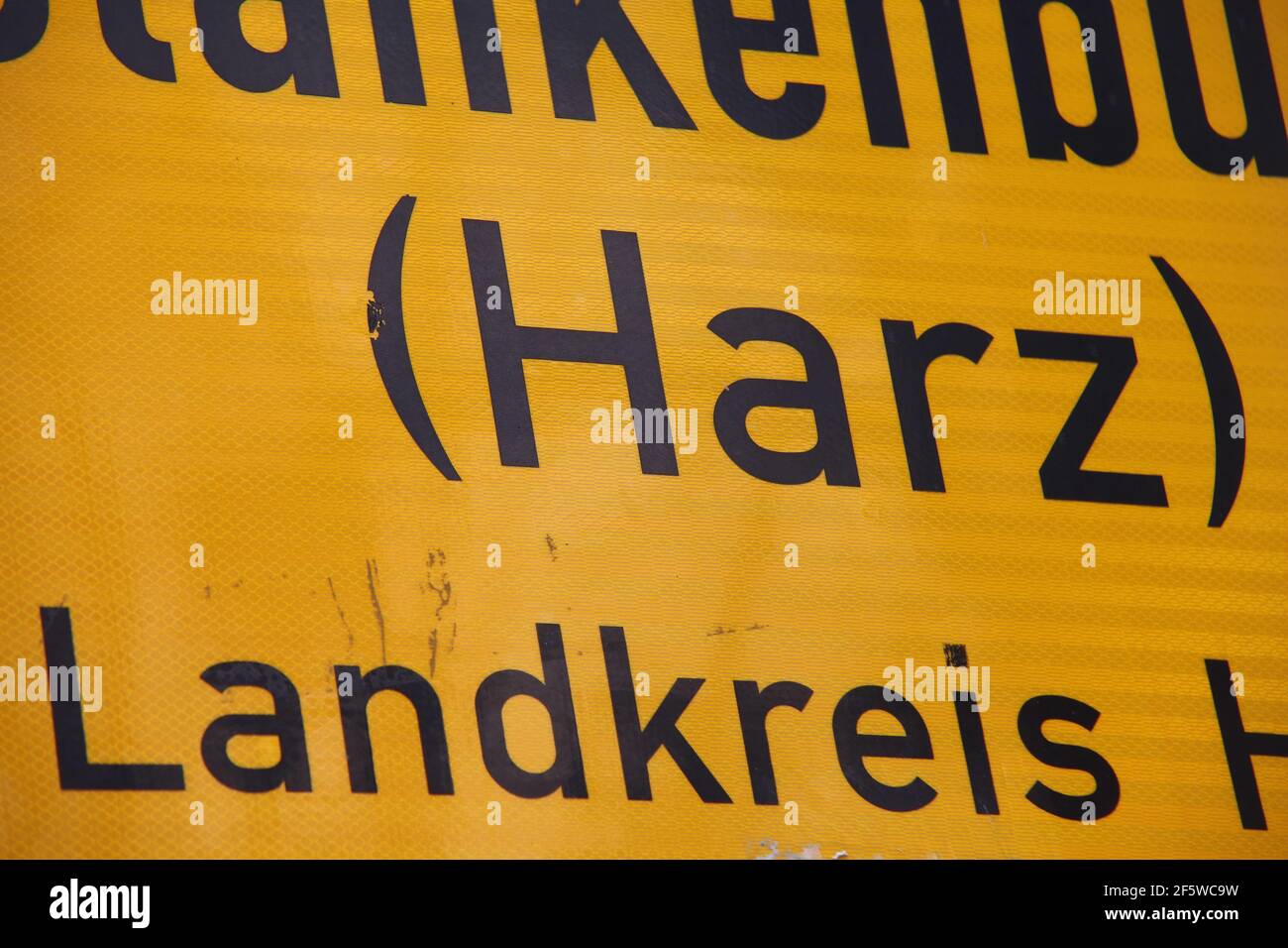 Blankenburg, Germany. 28th Mar, 2021. View of a place name sign with the inscription '(Harz) Landkreis Harz'. The district of Harz plans from 06.04.2021 in tourist places of the district the opening of outdoor gastronomy, retail and tourist leisure facilities. The basis for this is a pilot project that is currently being developed. With the inclusion of test centres and the PassGo app developed in Halberstadt, this would be a first step towards normality. Credit: Matthias Bein/dpa-Zentralbild/dpa/Alamy Live News Stock Photo