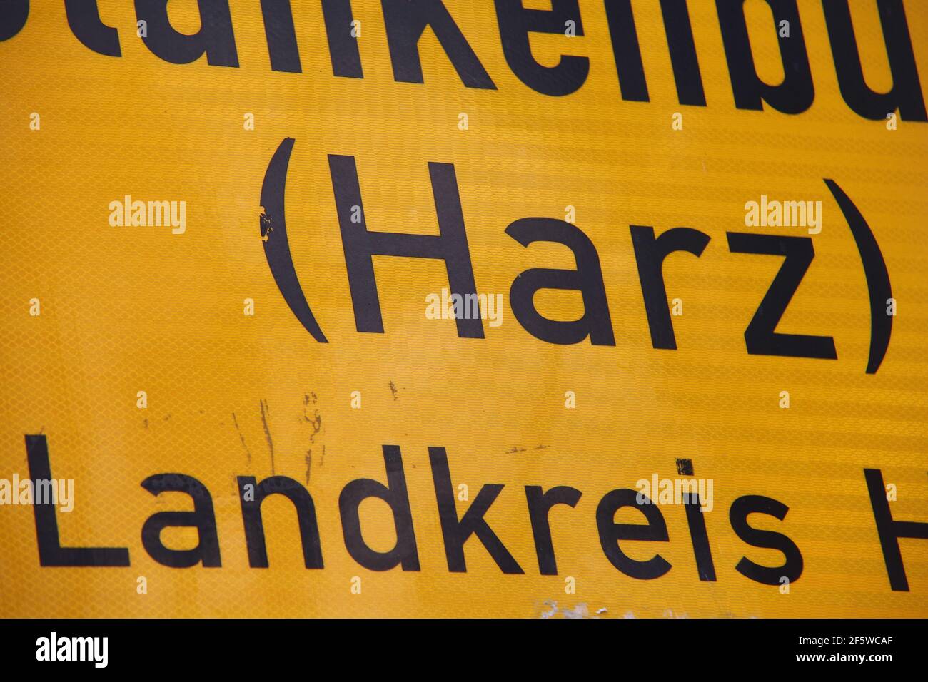 Blankenburg, Germany. 28th Mar, 2021. View of a place name sign with the inscription '(Harz) Landkreis Harz'. The district of Harz plans from 06.04.2021 in tourist places of the district the opening of outdoor gastronomy, retail and tourist leisure facilities. The basis for this is a pilot project that is currently being developed. With the inclusion of test centres and the PassGo app developed in Halberstadt, this would be a first step towards normality. Credit: Matthias Bein/dpa-Zentralbild/dpa/Alamy Live News Stock Photo