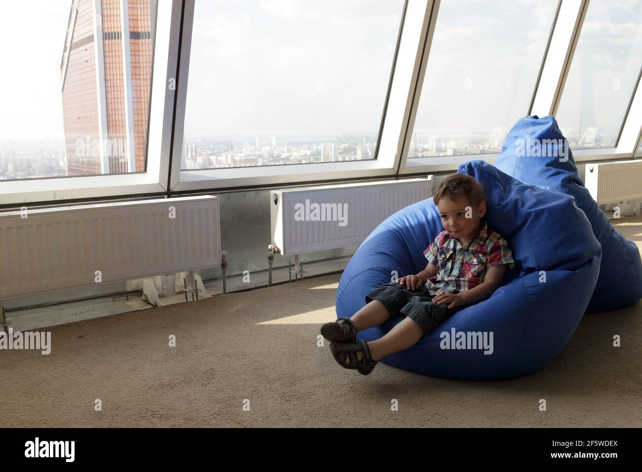 Boy sitting on bean bag hi-res stock photography and images - Alamy