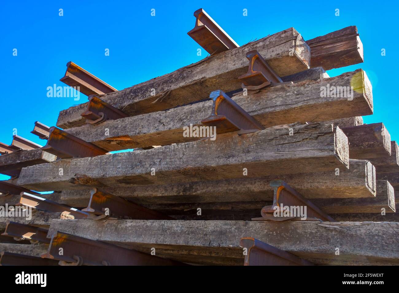 A stack of railroad ties and rail track sitting in a switching yard in El Paso, Texas Stock Photo