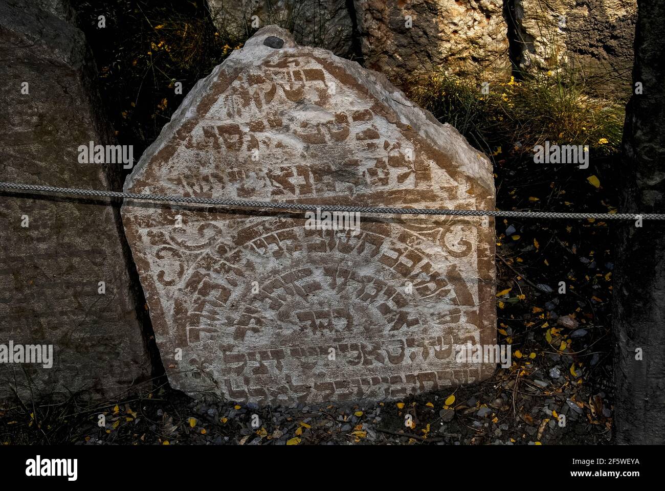 Stones or pebbles left on top of this ancient tombstone, in accordance ...