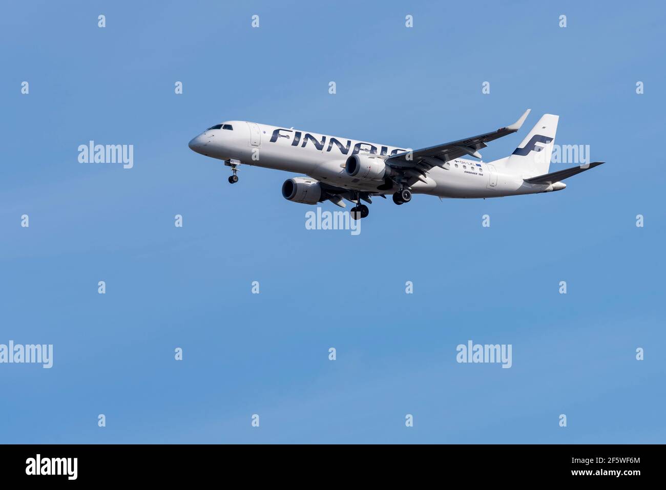 Finnair Embraer ERJ 190 jet airliner plane OH-LKL on finals to land at London Heathrow Airport, UK, in blue sky. Finnish, flag carrier airline Finland Stock Photo