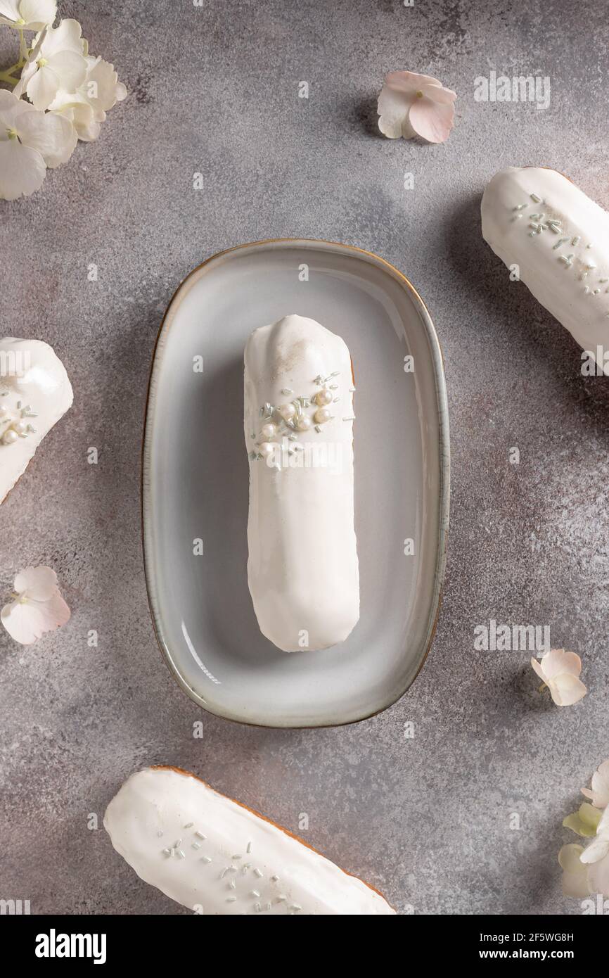 french white chocolate eclairs on hydrangea flowers background Stock