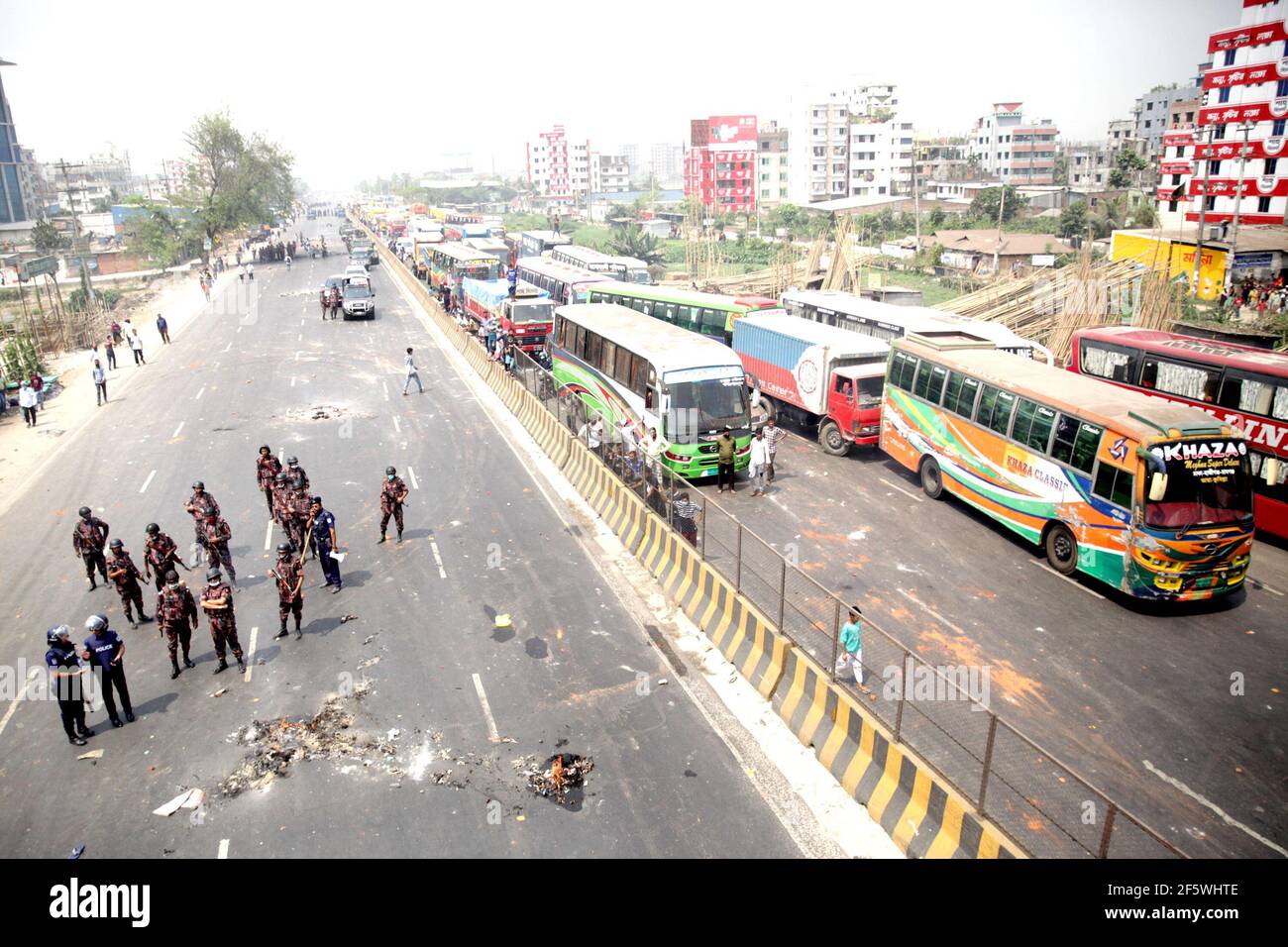 Narayanganj. 28th Mar, 2021. Members of the Border Guard Bangladesh (BGB) stand guard on a street during a countrywide protest in Narayanganj, Bangladesh, March 28, 2021. Parts of Bangladesh including capital Dhaka continued to be affected by protests called by a religious group. At least 10 people were injured on Sunday. Credit: Xinhua/Alamy Live News Stock Photo