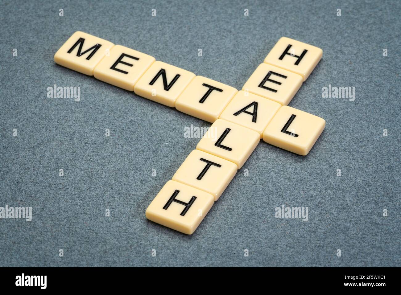 mental health crossword in ivory letter tiles against textured handmade