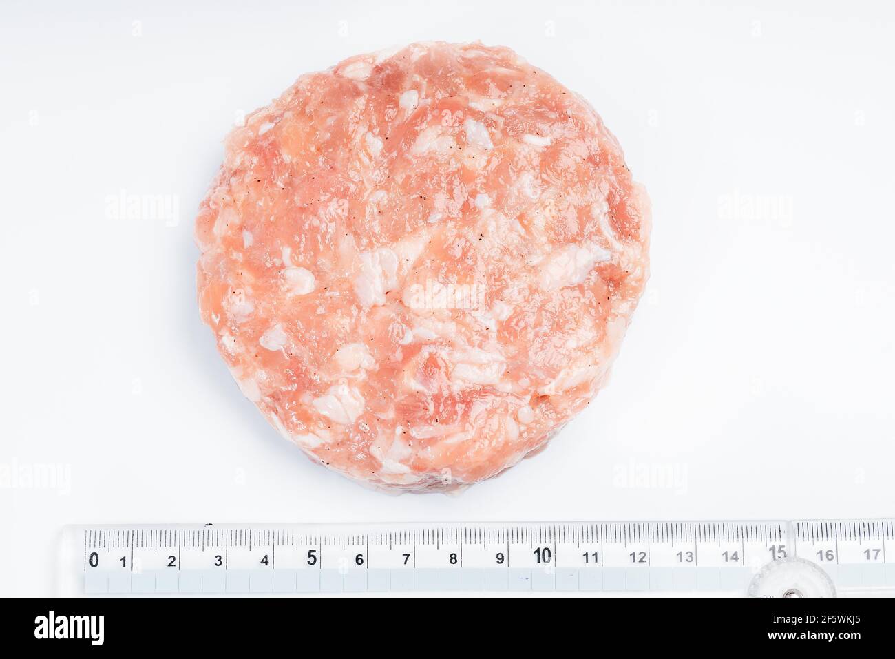 Chicken hamburger close-up with a ruler for the exact size of the ...