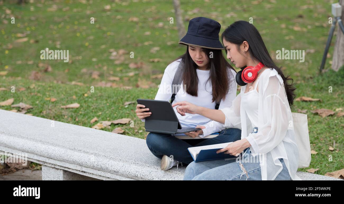 College asian students studying together in campus ground. Stock Photo