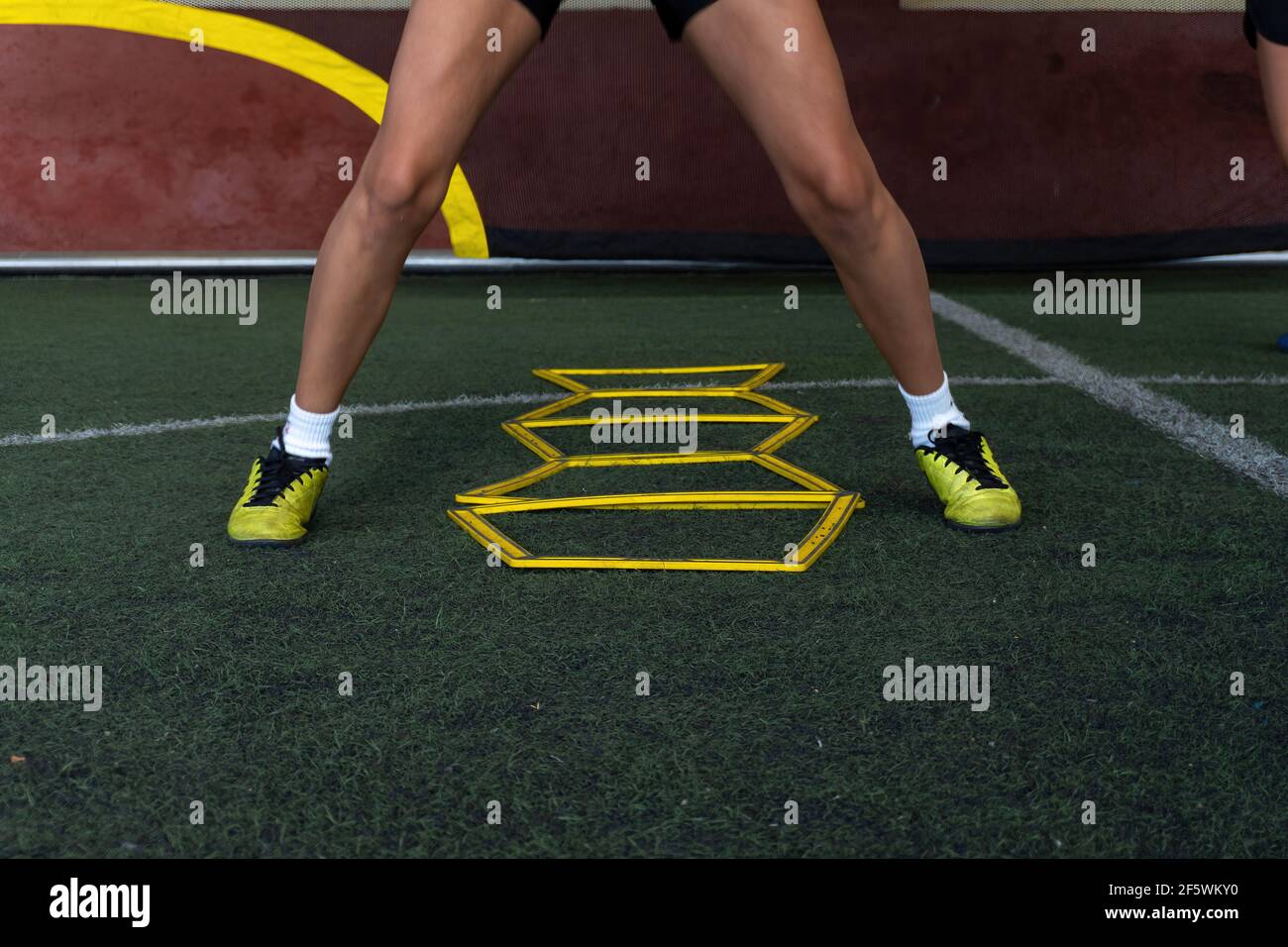 A football player on a hexagonal speed and agility training ladder