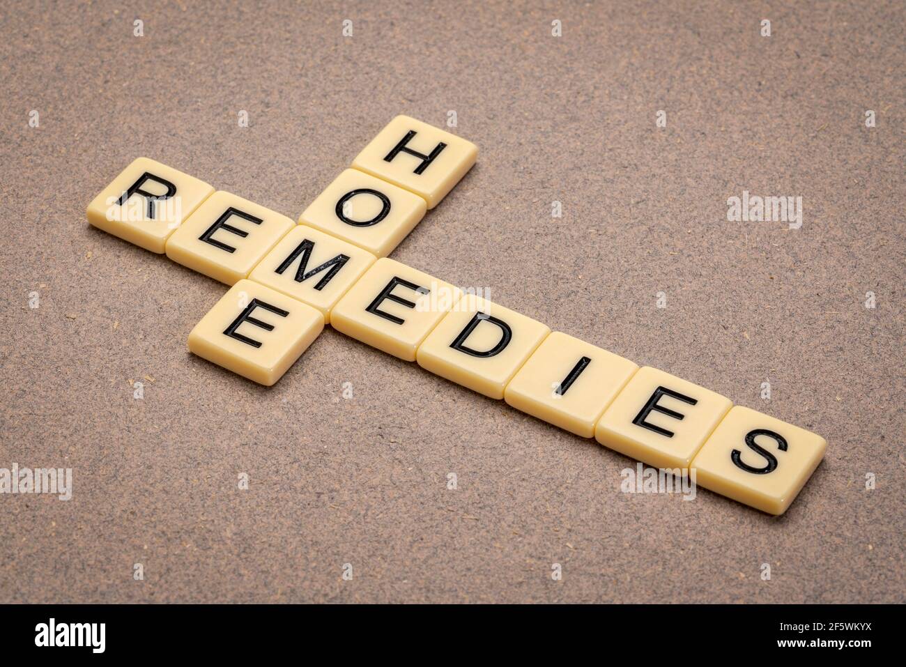 home remedies crossword in ivory letter tiles against textured paper, lifestyle and self care concept Stock Photo