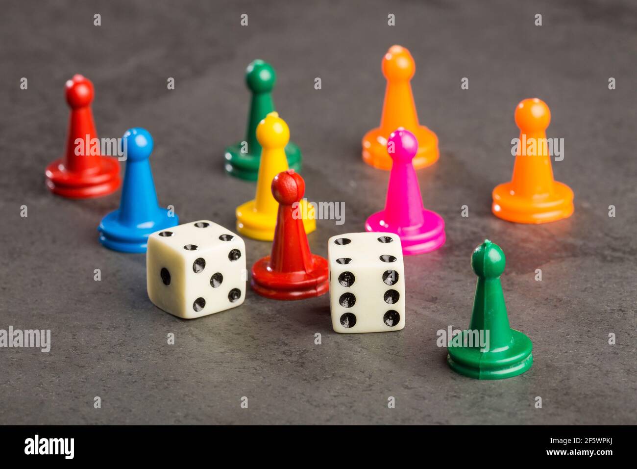 Game pieces with dices on slate Stock Photo