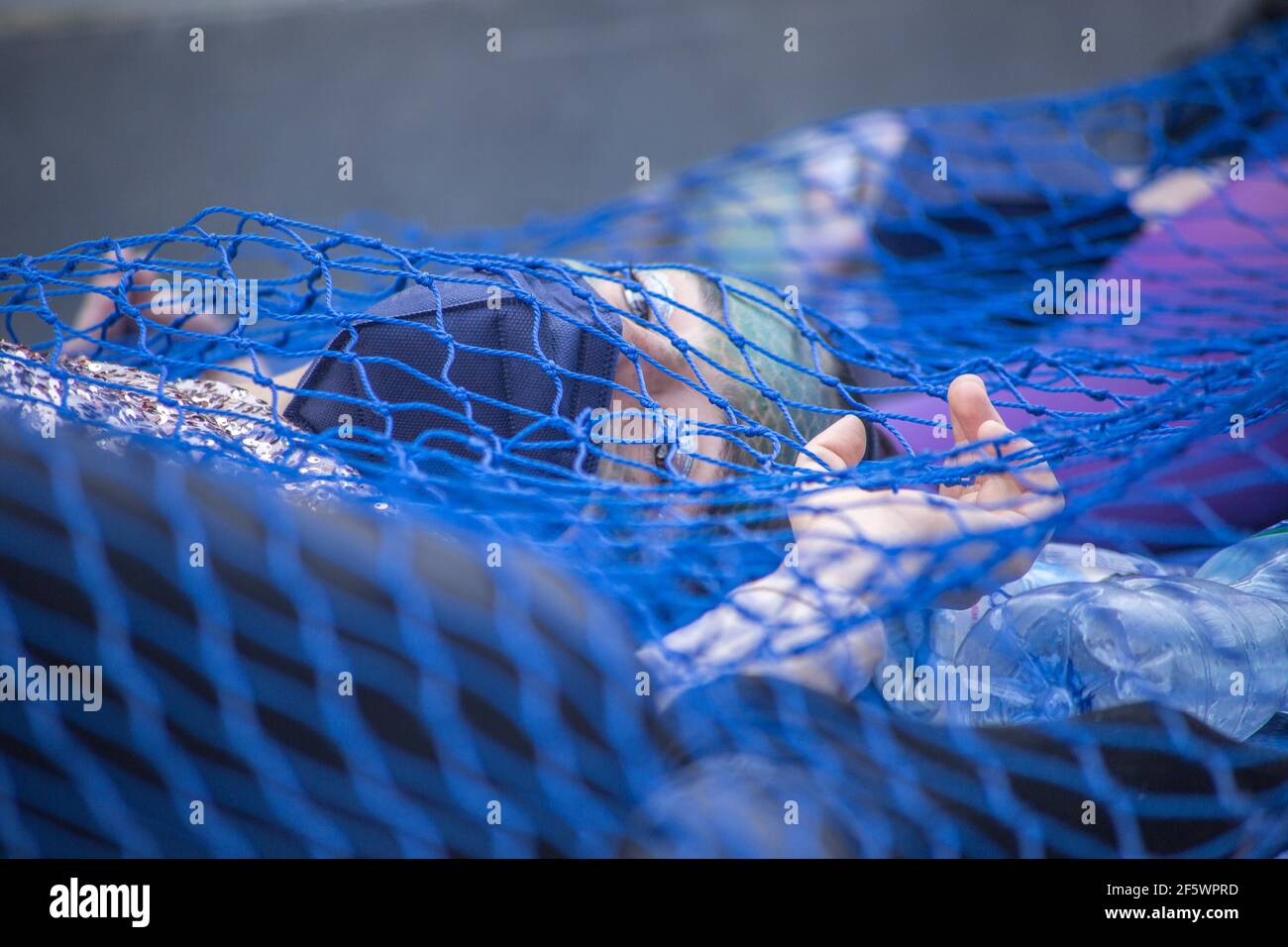 Barcelona, Catalonia, Spain. 28th Mar, 2021. Demonstrators in performance are seen in nets dressed as fish.The animalist association, Barcelona Animal Save, which is part of the international organization, The Save Movement, dedicated to activism for animals, has carried out a performance to protest against the pollution of the seas, fishing and aquariums on that Sunday 28 of March in front of the Barcelona Aquarium. Credit: Thiago Prudencio/DAX/ZUMA Wire/Alamy Live News Stock Photo