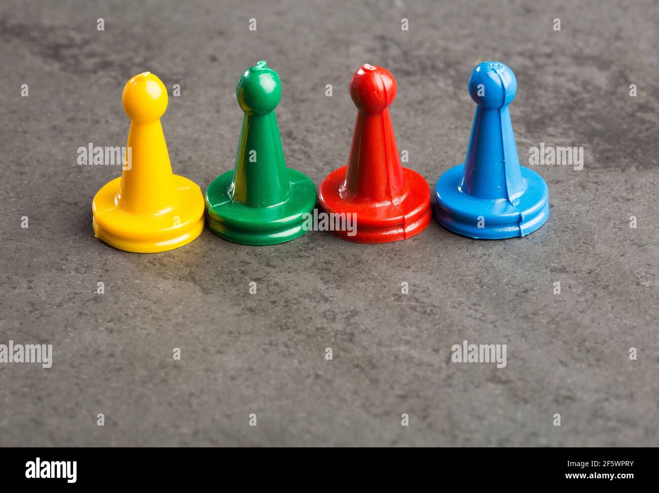Game pieces with dices on slate Stock Photo