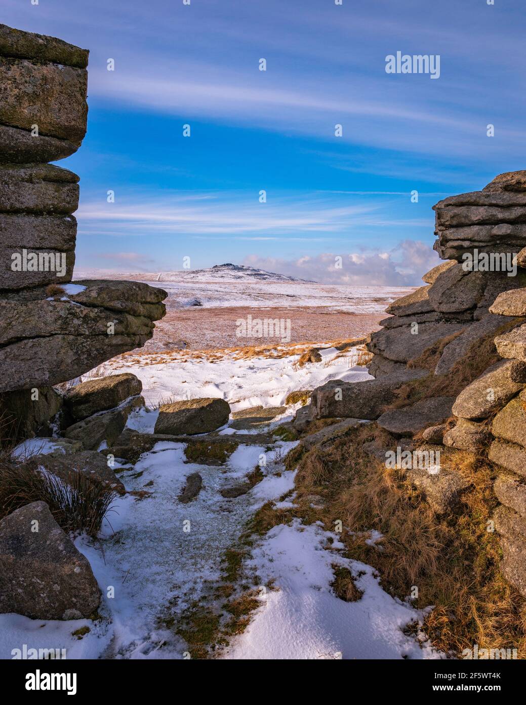 Granite outcrop formations in winter snow on East Mill Tor, Dartmoor National Park, Devon, England, UK. Stock Photo