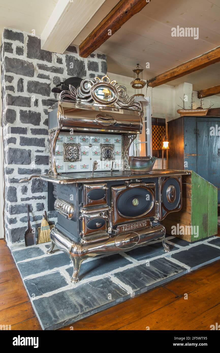 Antique President wood-burning cooking stove made by A. Belanger company in  corner of dining room inside old circa 1790 Canadiana cottage style home  Stock Photo - Alamy