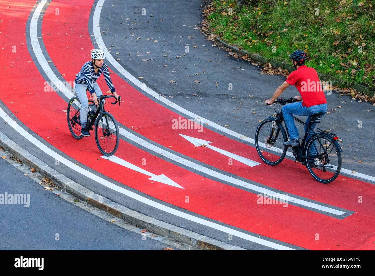 Cyclists on the way on inner-city bicycle road Stock Photo