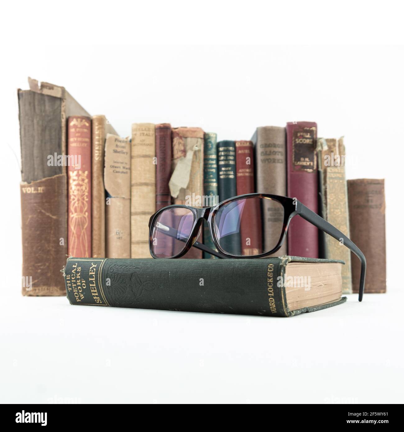 Rare old Vintage books from library Shelley poems, top of an old eyewear glasses on white background Stock Photo