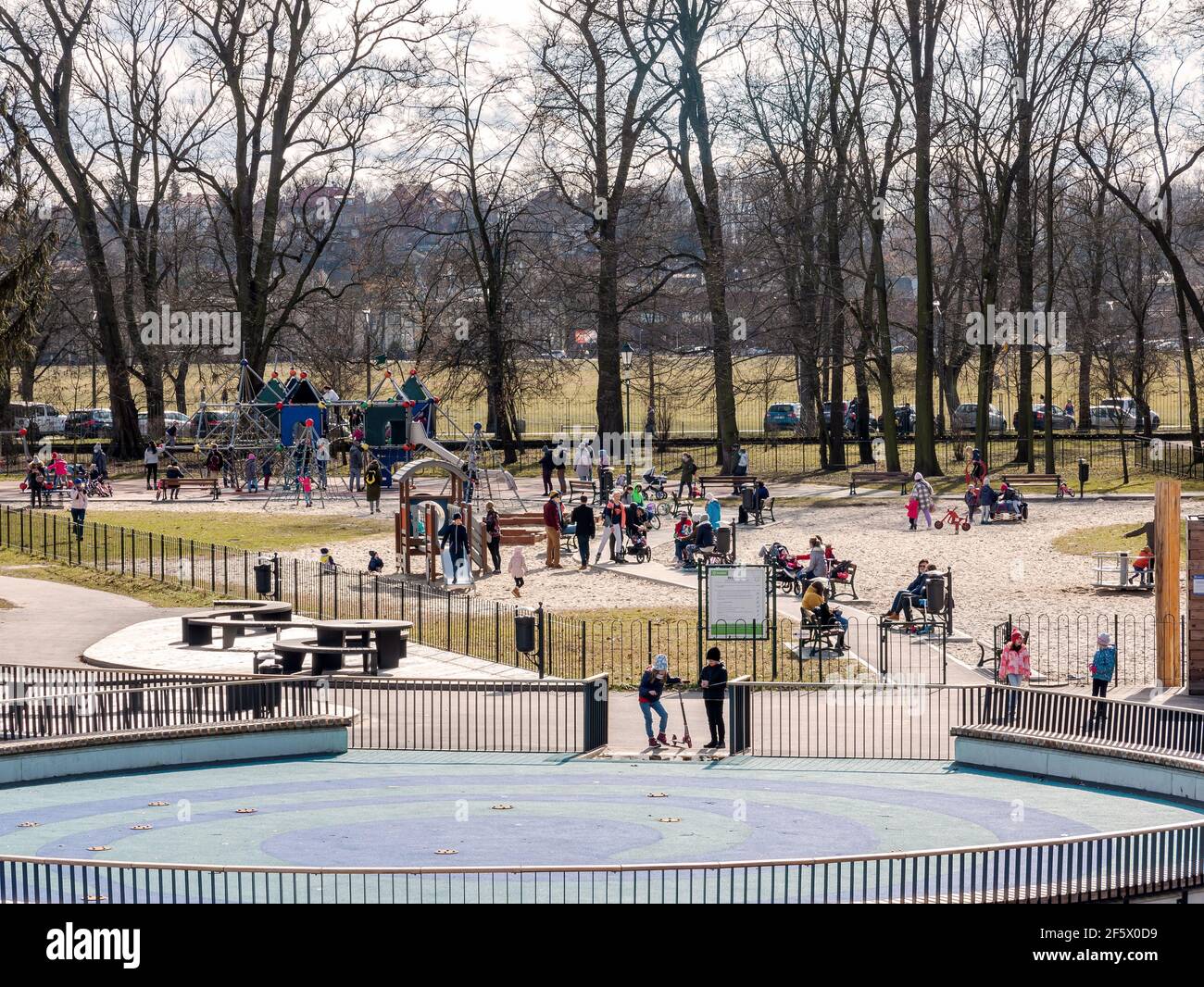 Jordan park playground in Krakow, public area during covid 19 pandemic group  of people adults and children in face masks new normal lifestyle high ang  Stock Photo - Alamy