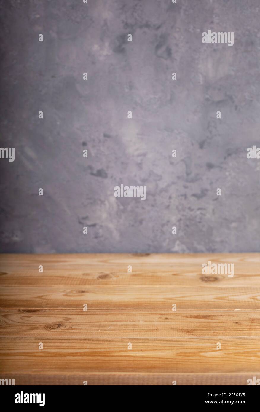 wooden desk table or shelf near grey concrete wall background texture surface Stock Photo