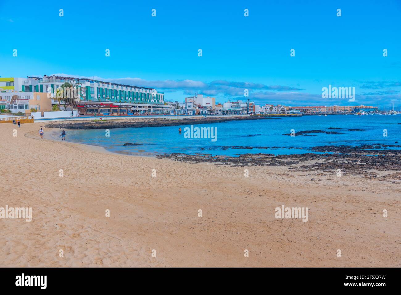 Corralejo, Spain, Janury 25, 2021: People are enjoying a sunny day at a beach in Corralejo, Fuerteventura, Canary islands, Spain. Stock Photo