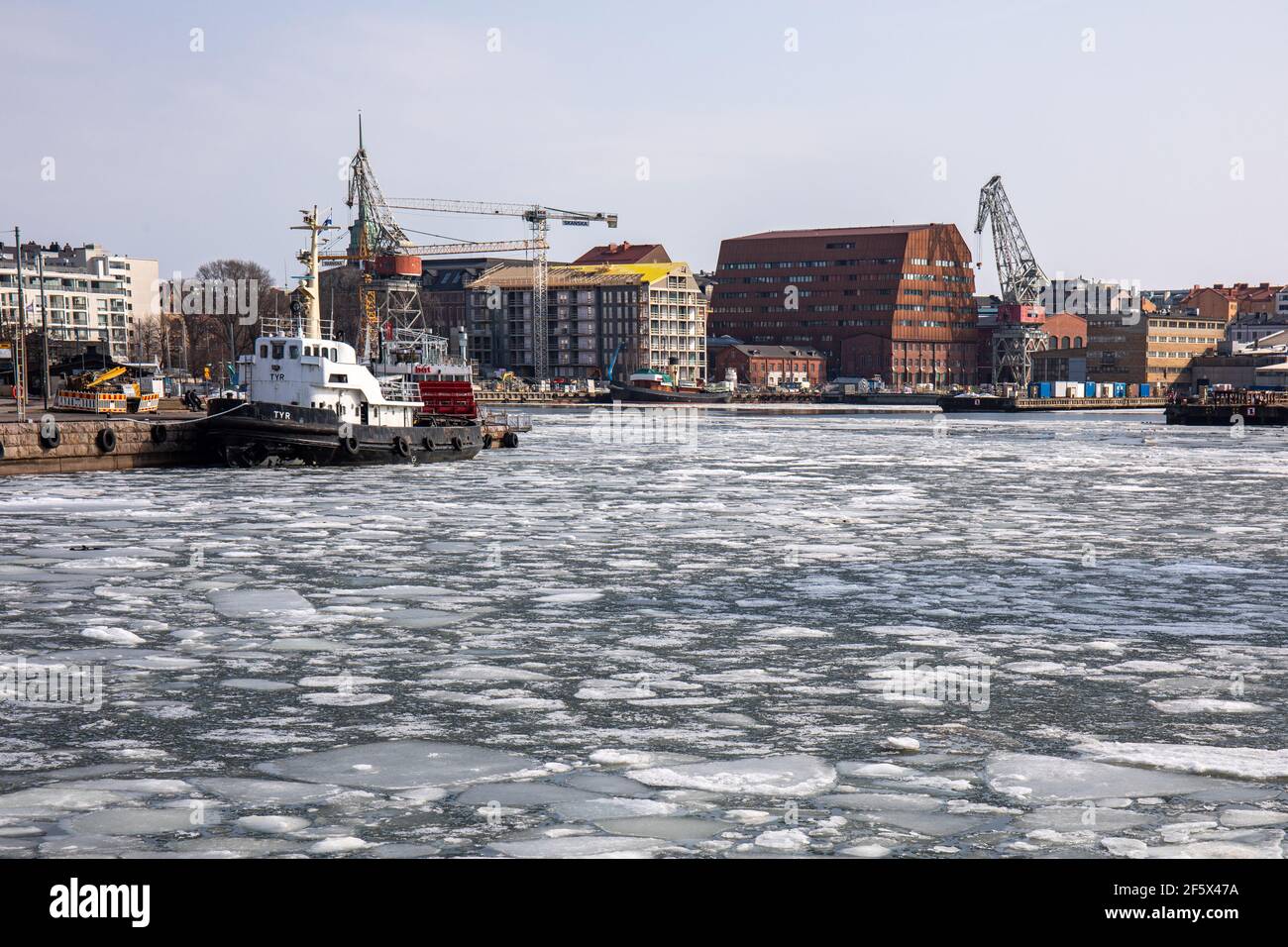 Ice floes on Hietalahti Bay, European Chemicals Agency headquarters building in the background. Helsinki, Finland. Stock Photo