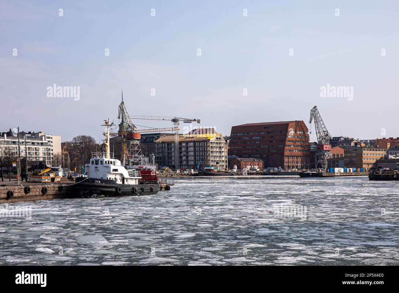 Ice floes on Hietalahti Bay with ECHA HQ in the background in Helsinki, Finland Stock Photo