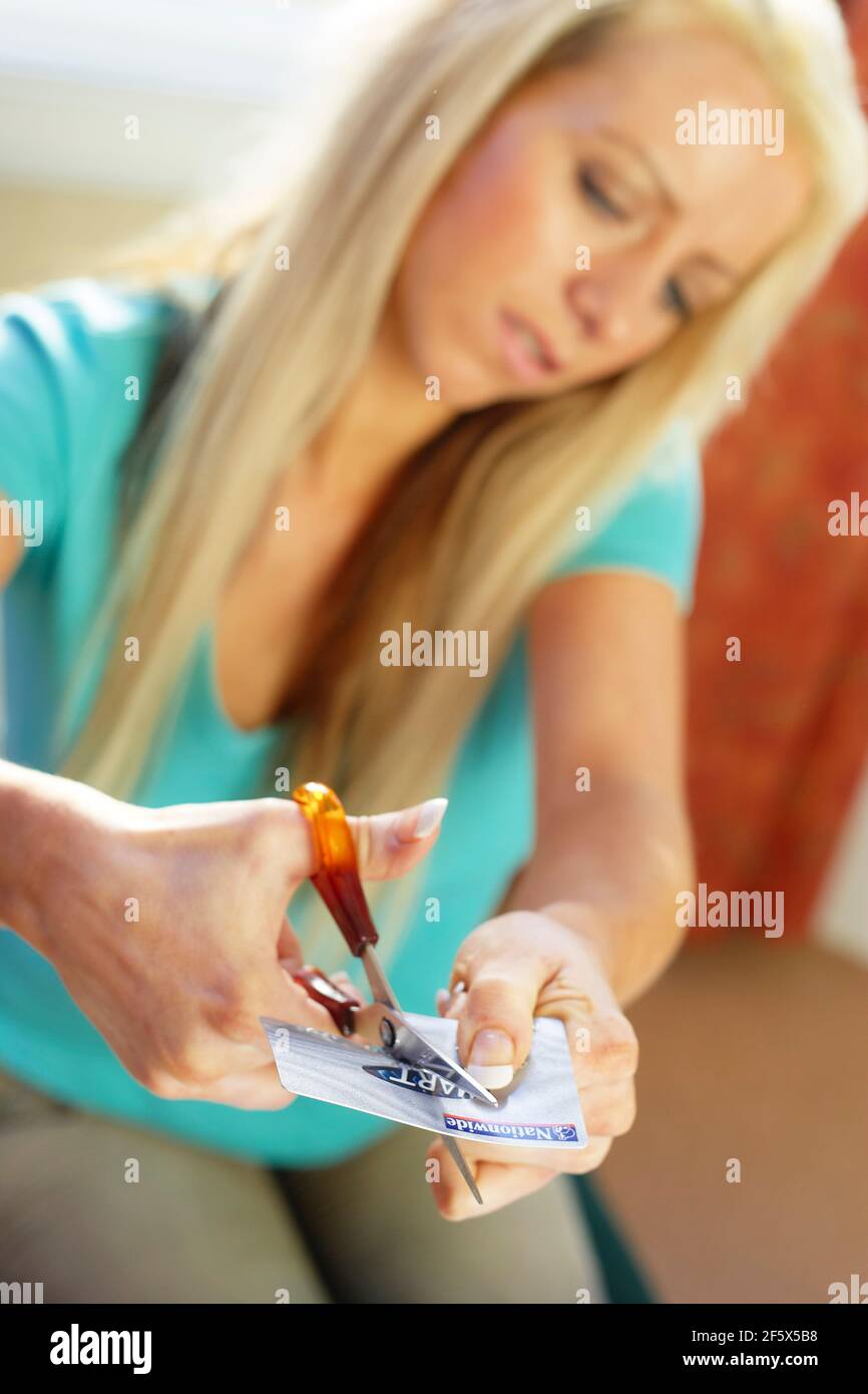 Woman cutting credit card in half Stock Photo Alamy