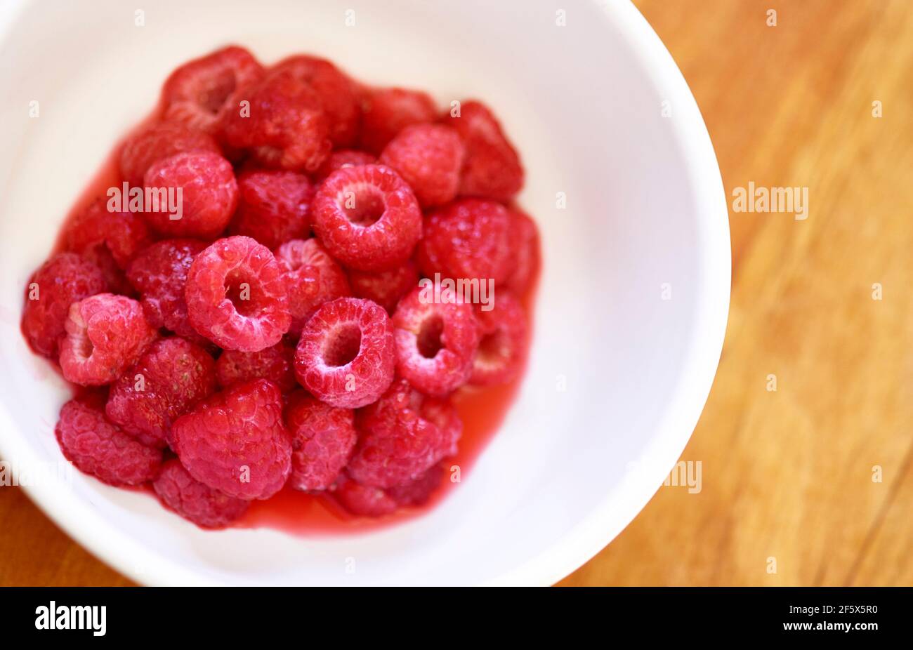 Bowl of fresh Raspberries Stock Photo