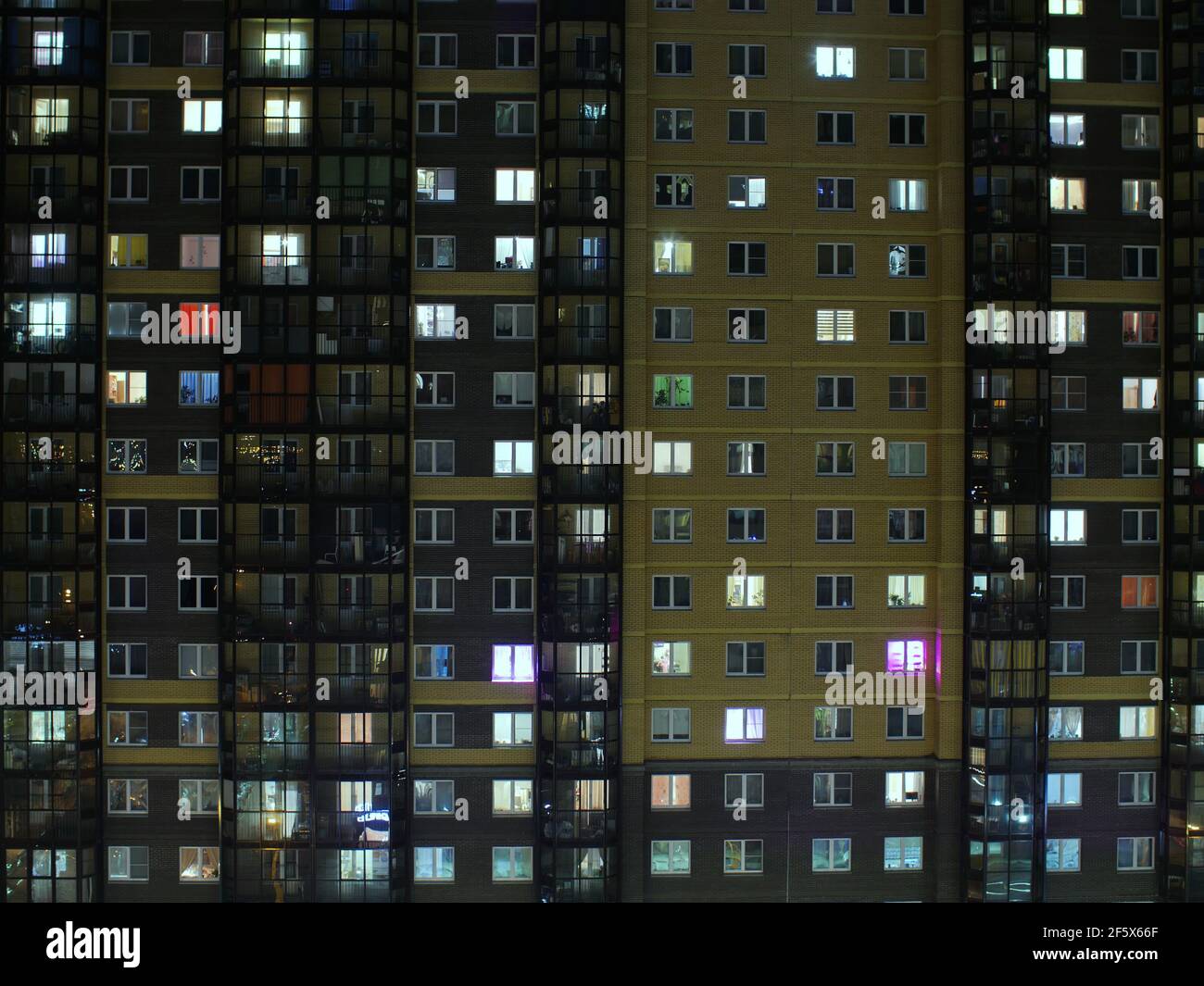 blinking windows of the building at night Stock Photo