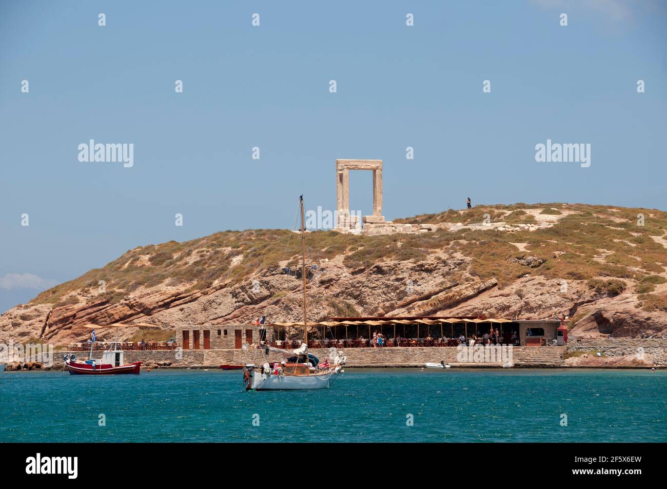 Panoramic view of Portarae and the Temple of Apollo, Naxos Island, Greece. In the background is the cloudless blue sky. Travel and Tourism Concept Stock Photo