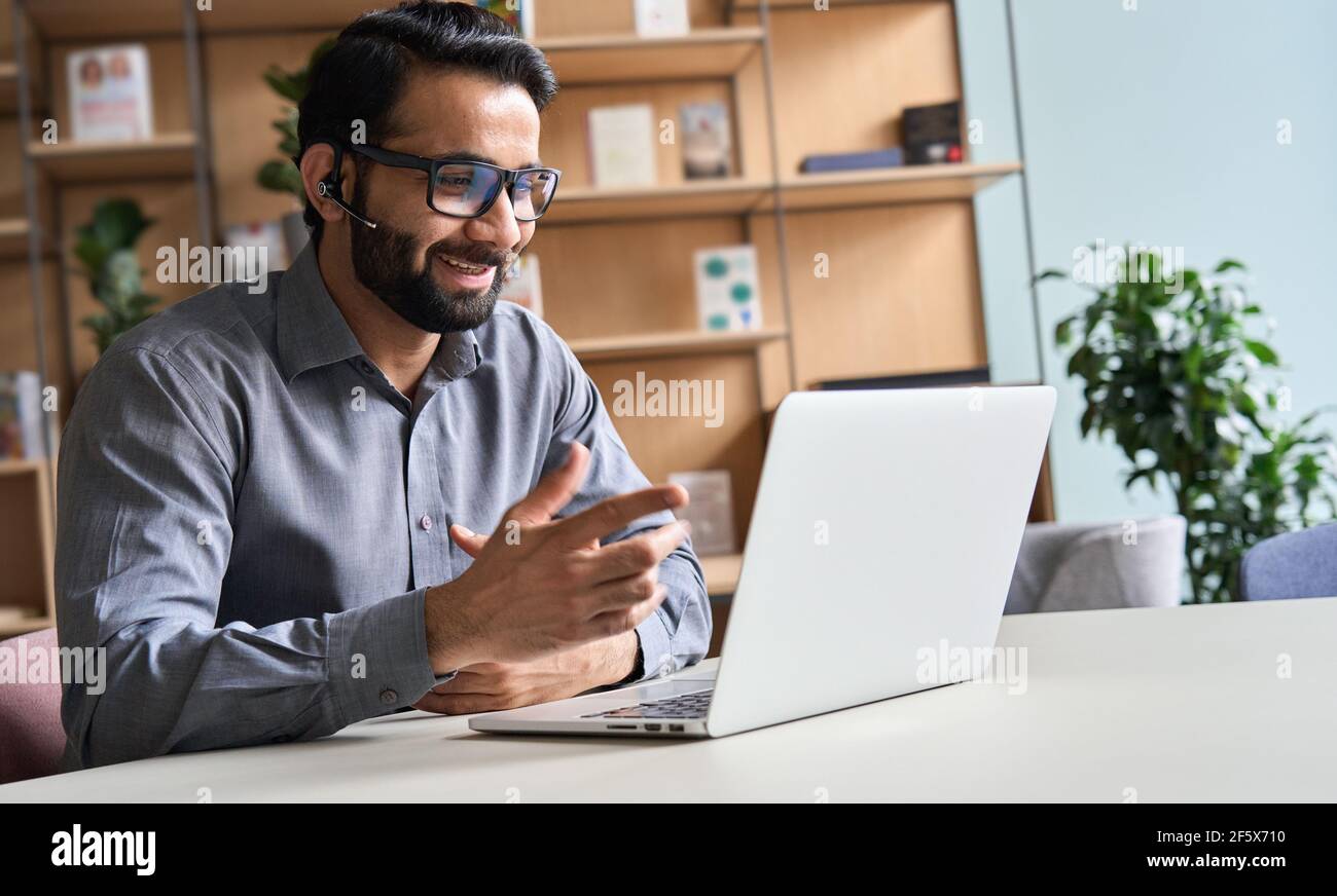 Happy indian business man remote teacher giving distance learning class. Stock Photo