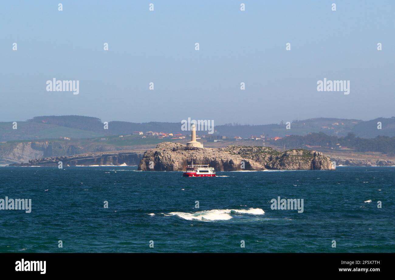 Regina ferry tourist boat passing in front of Mouro Island on rough seas on a windy spring afternoon Santander Cantabria Spain Stock Photo