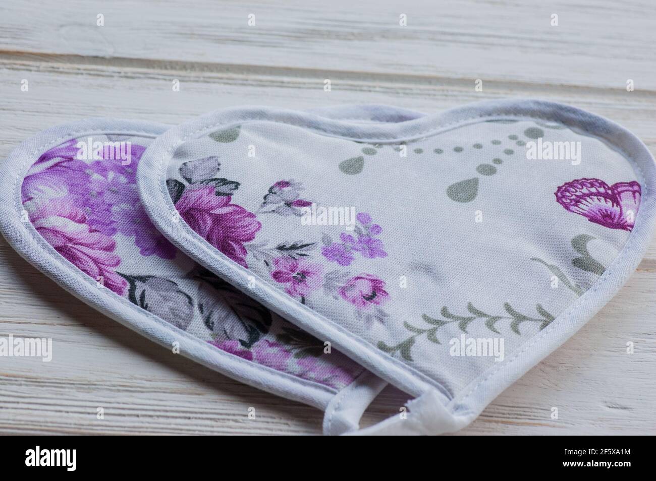 Oven mitt or potholder on the wooden background. Cloth oven mitts Stock Photo