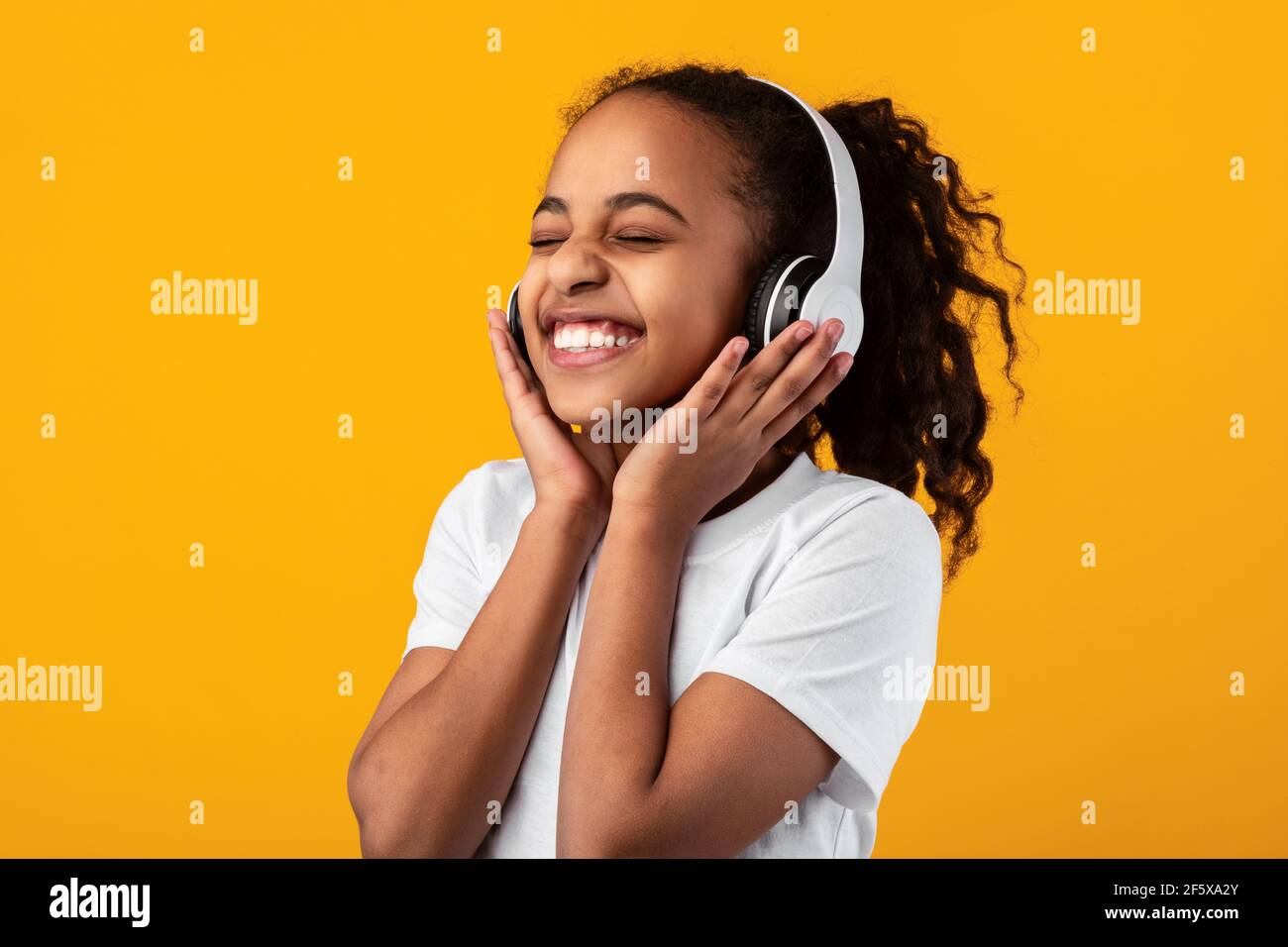 Smiling Young Black Girl Listening To Music In Headset Stock Photo Alamy