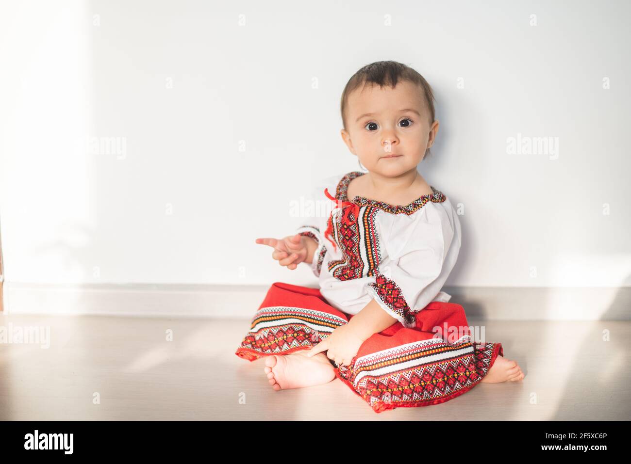 Portrait of cute infant baby girl wearing a traditional Romanian costume Stock Photo