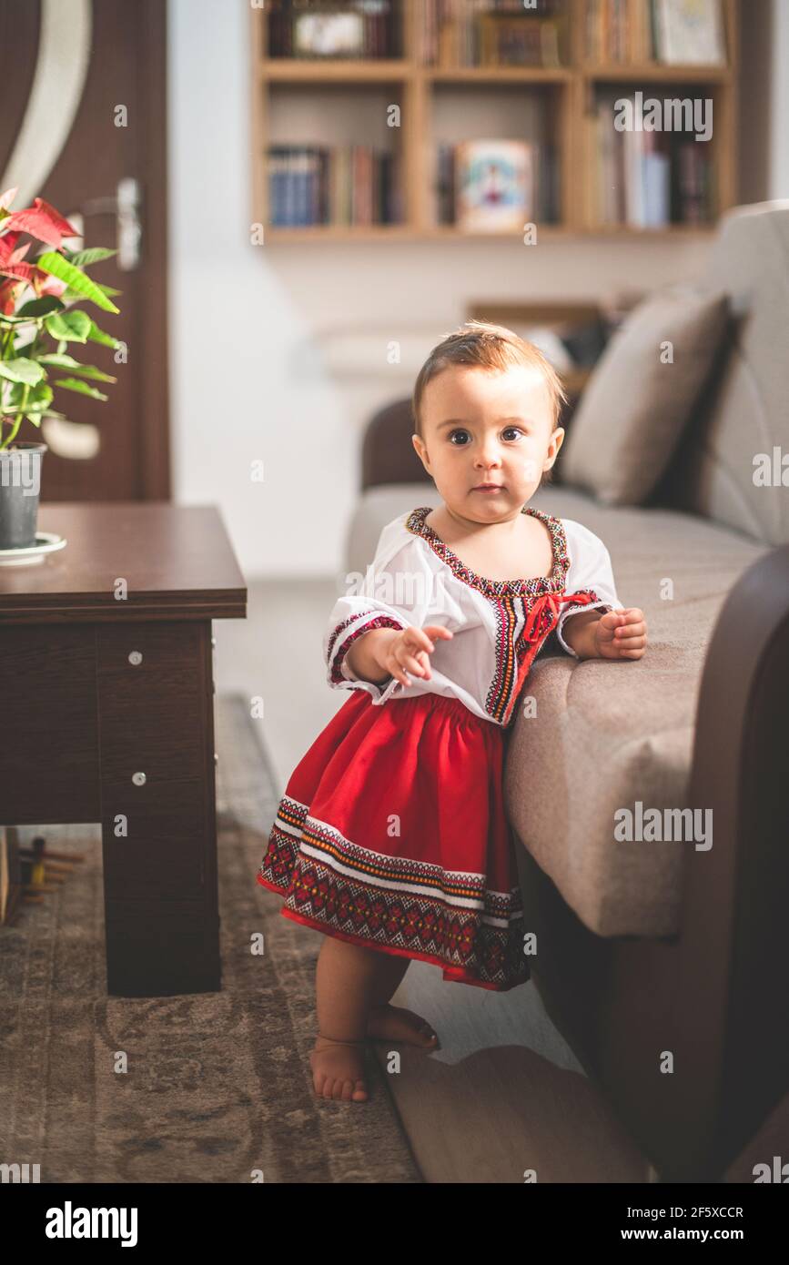 Portrait of cute infant baby girl wearing a traditional Romanian costume Stock Photo