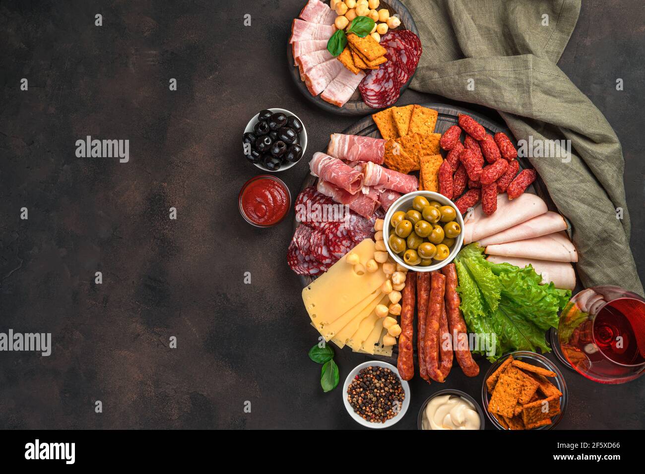 Charcuterie board. Different types of sausages, cheese, lettuce and