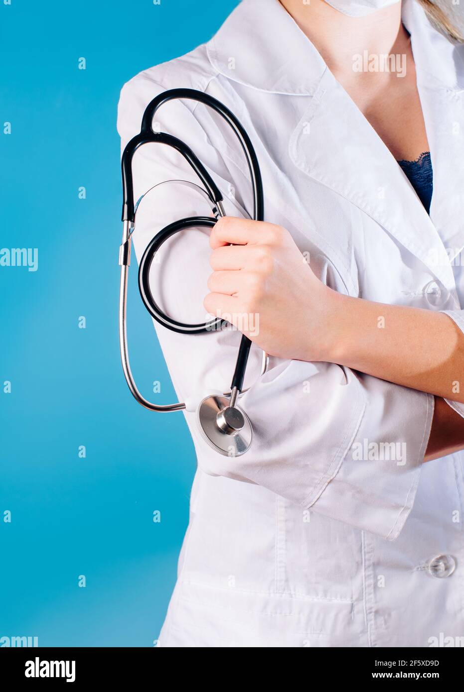 Girl doctor in a white coat holds a stethoscope in her hands. Doctor  cardiologist with stethoscope in hand.Health concept Stock Photo - Alamy