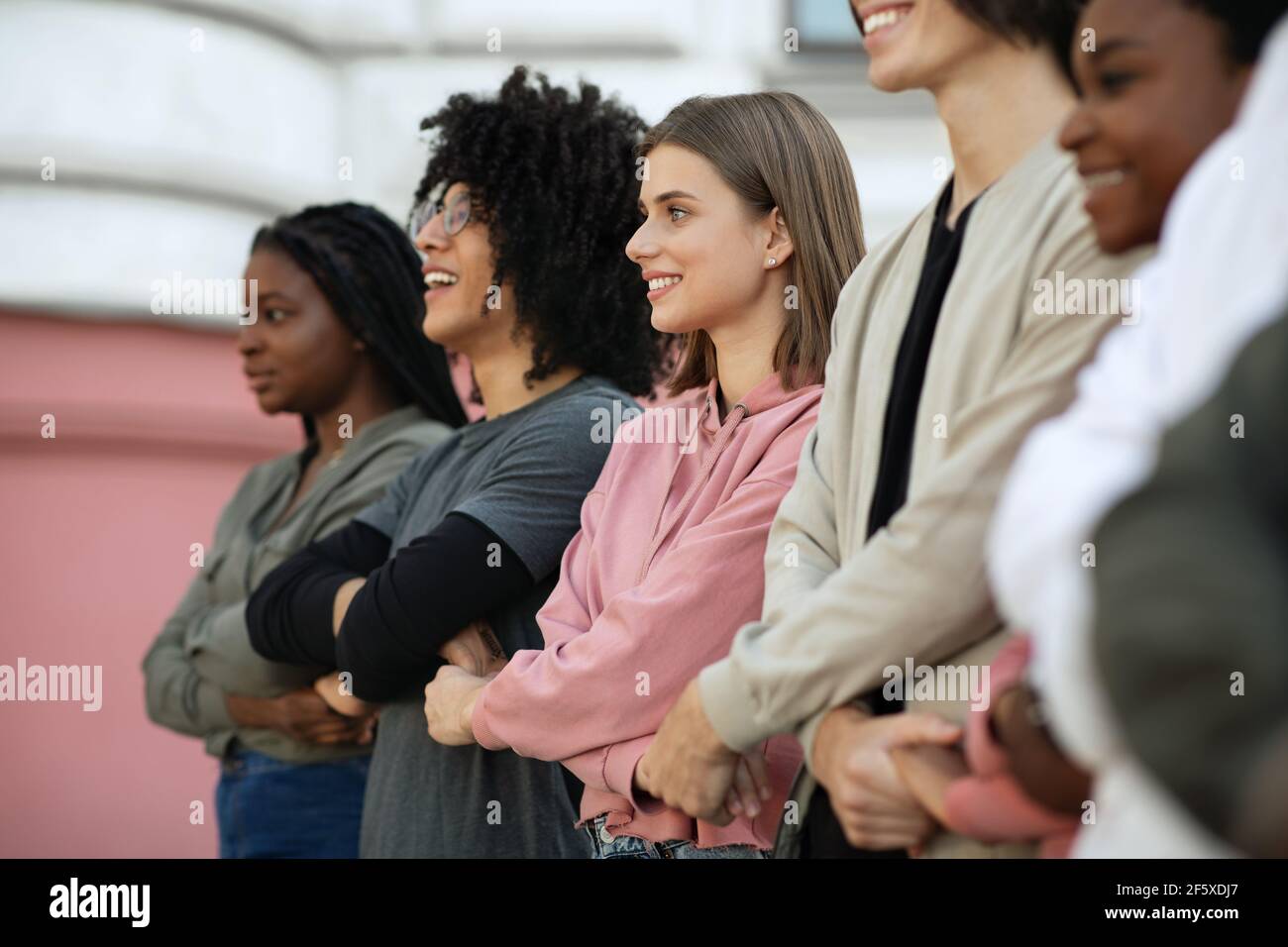 International group of cheerful students holding hands Stock Photo - Alamy