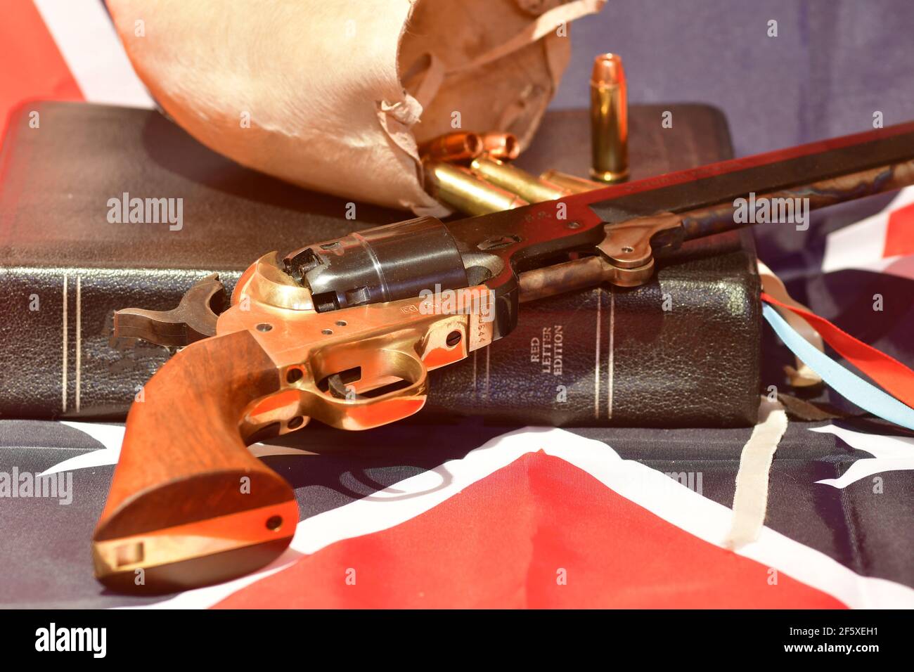 The Holy Bible, bull scrotum, bullets, and revolver on the rebel flag Stock Photo